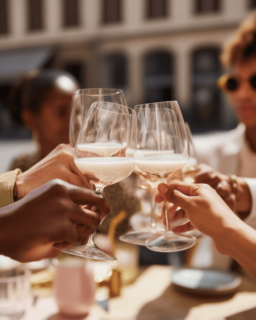 Friends raising glasses at an outdoor table