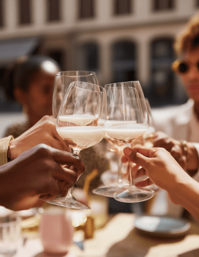 Friends raising glasses at an outdoor table